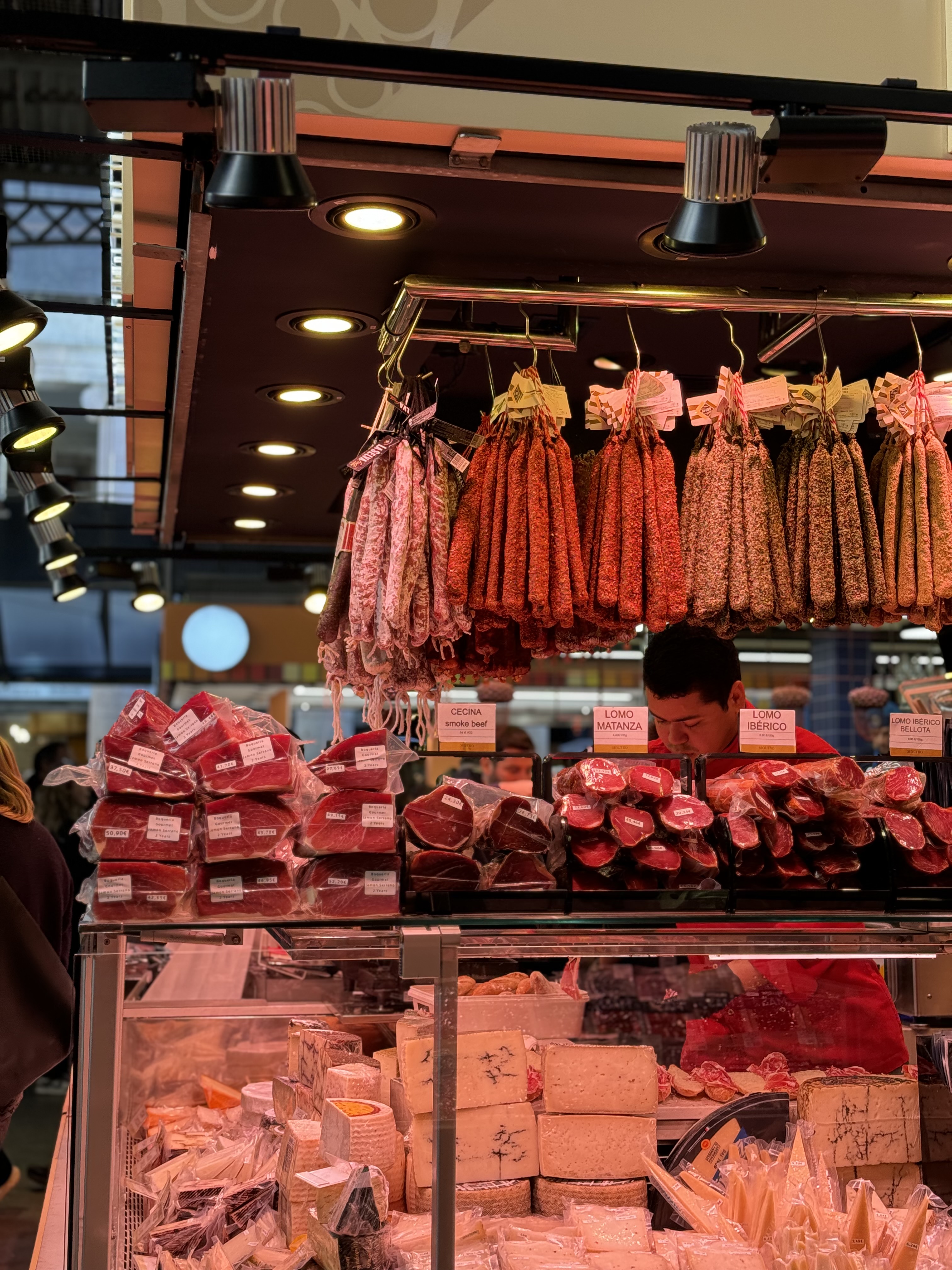 Cured jamón and cheese at a stall inside La Boqueria market