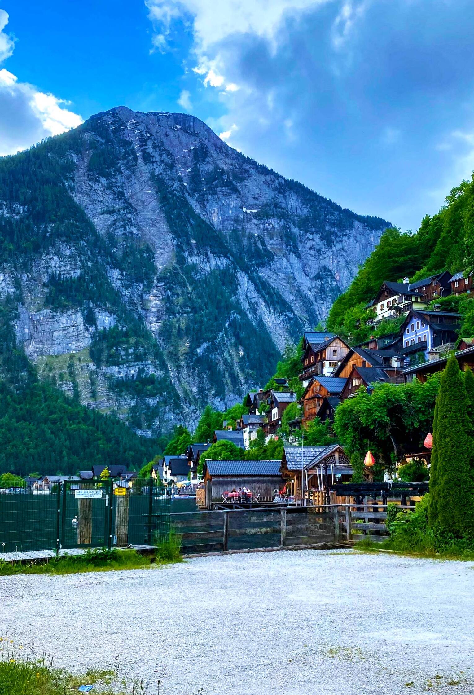 Hallstatt village view in the rain - pastel houses and church steeple emerging from morning mist